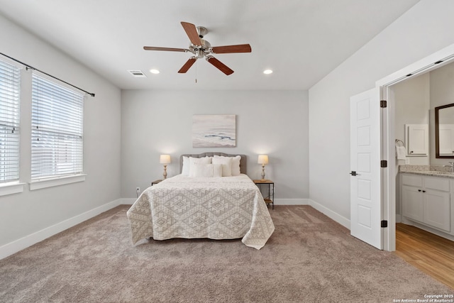 bedroom featuring visible vents, light carpet, recessed lighting, connected bathroom, and baseboards