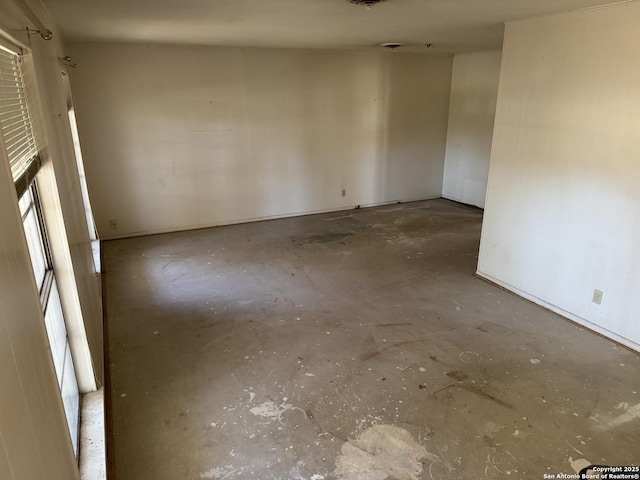 unfurnished room featuring unfinished concrete floors