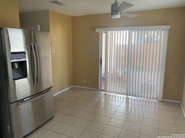 kitchen with light tile patterned floors, a ceiling fan, visible vents, stainless steel fridge with ice dispenser, and a textured ceiling