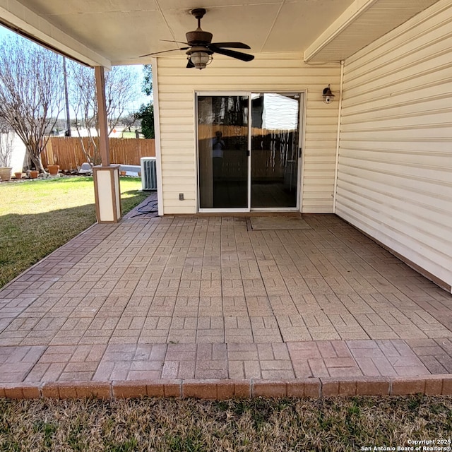 view of patio with fence, central AC, and ceiling fan