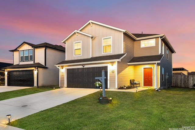 traditional-style home featuring board and batten siding, a front lawn, fence, driveway, and an attached garage