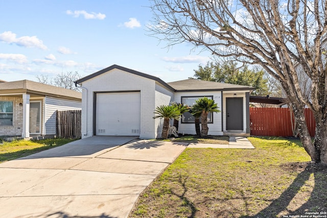 view of front of house featuring fence, driveway, an attached garage, a front lawn, and brick siding