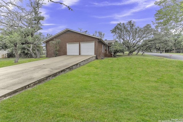 view of front of home featuring a front lawn, concrete driveway, brick siding, and an attached garage