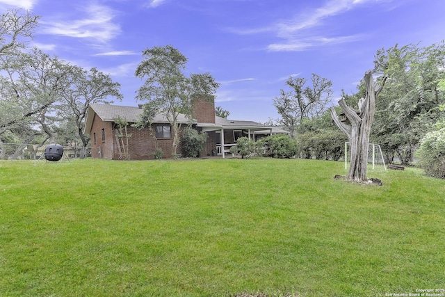 view of yard with a sunroom