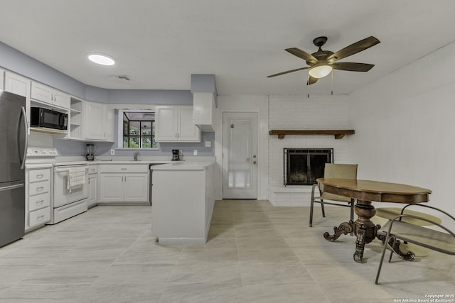 kitchen featuring electric stove, white cabinetry, freestanding refrigerator, black microwave, and light countertops