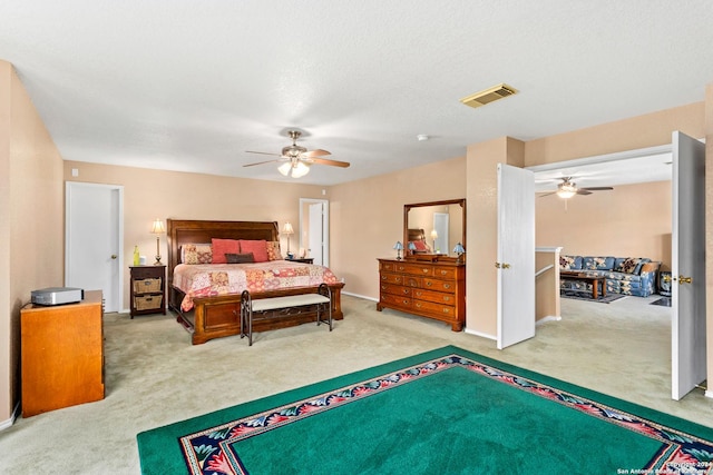 carpeted bedroom with baseboards, visible vents, and ceiling fan