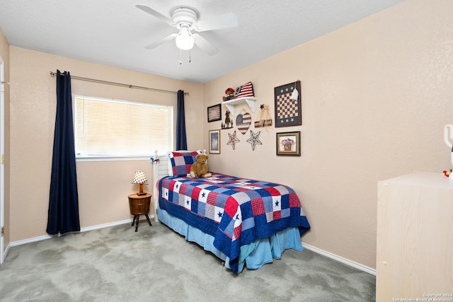 bedroom with ceiling fan, baseboards, and carpet