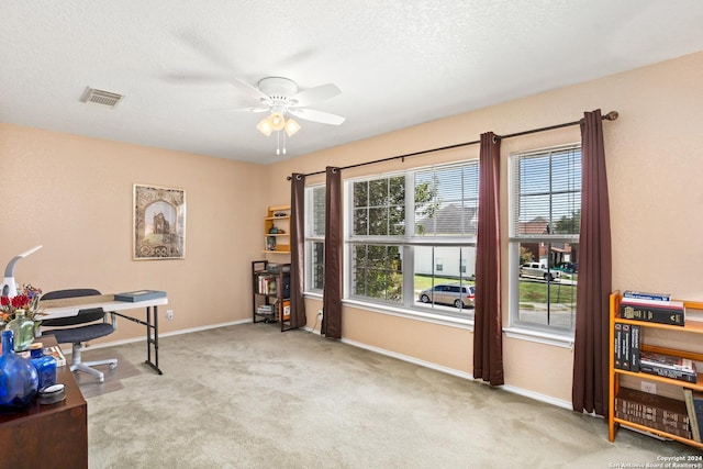 office with visible vents, carpet flooring, a textured ceiling, and baseboards