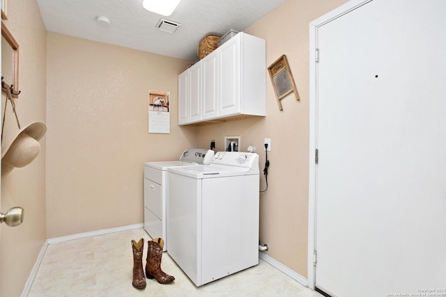 laundry room featuring visible vents, cabinet space, separate washer and dryer, and baseboards