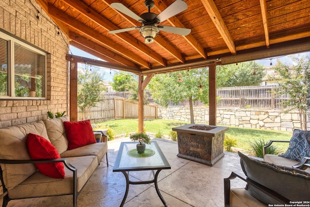 view of patio with ceiling fan, an outdoor living space with a fire pit, and a fenced backyard