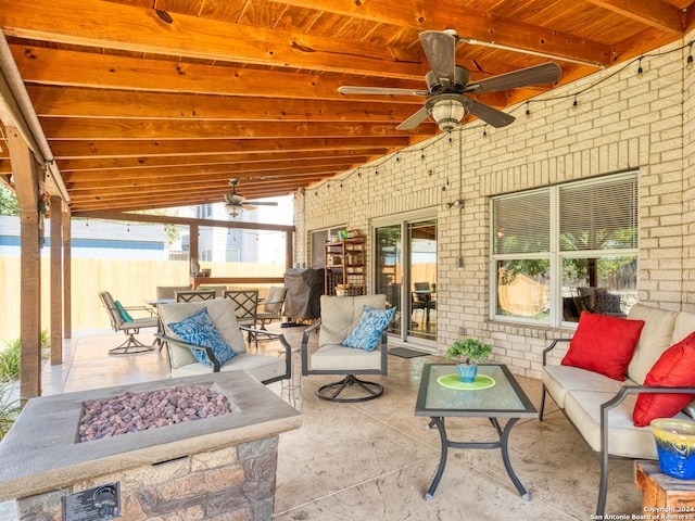 view of patio with an outdoor living space with a fire pit, ceiling fan, and fence