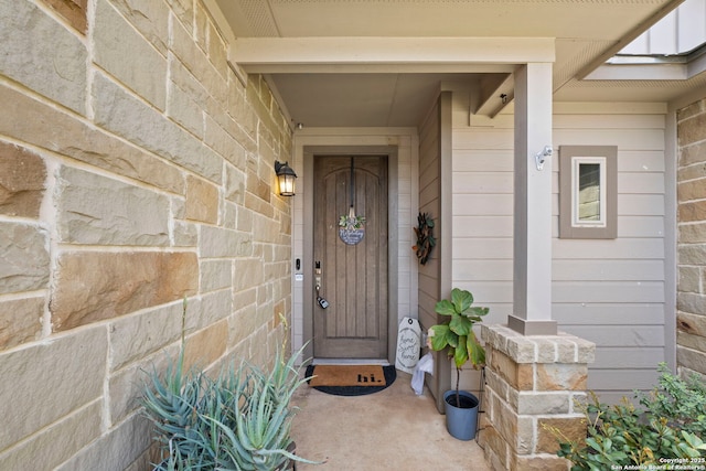 doorway to property featuring stone siding