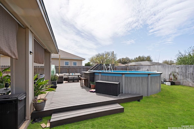 wooden terrace featuring a fenced in pool, a yard, a fenced backyard, and outdoor lounge area