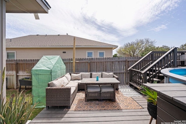 wooden deck featuring a fenced backyard and an outdoor hangout area