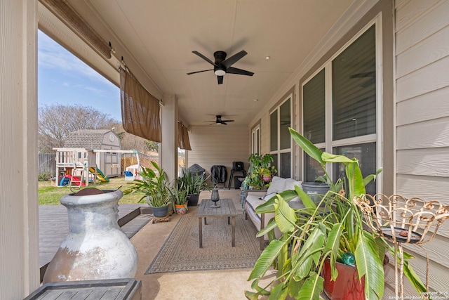 view of patio / terrace with ceiling fan and a playground