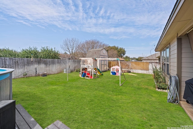 view of yard featuring a playground and a fenced backyard