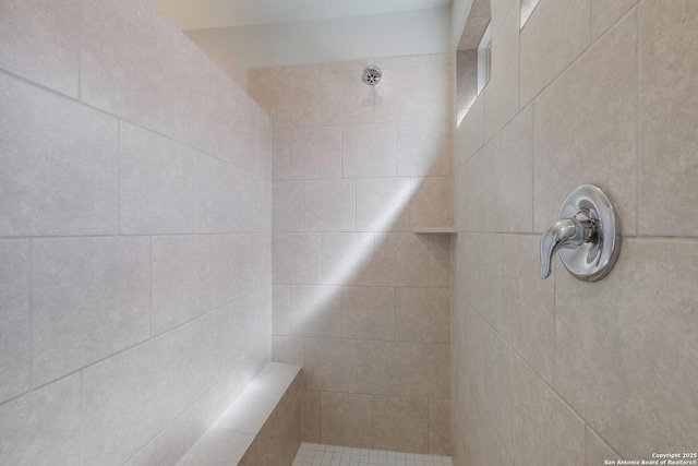 full bath featuring a tile shower