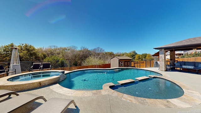 view of swimming pool with a patio, an outbuilding, a fenced backyard, a pool with connected hot tub, and an outdoor hangout area