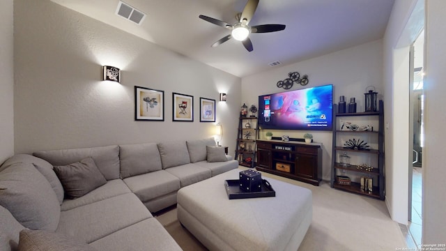 living room featuring light carpet, visible vents, and ceiling fan