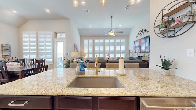 kitchen with visible vents, dark brown cabinetry, a healthy amount of sunlight, and open floor plan