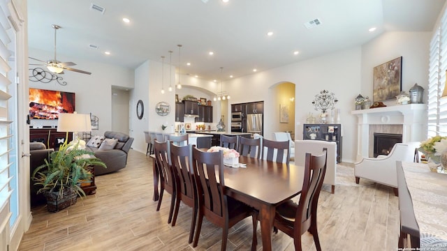 dining area with visible vents, a fireplace, and light wood finished floors