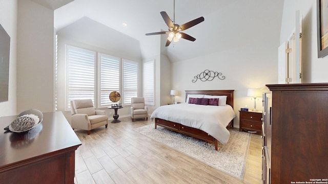 bedroom featuring high vaulted ceiling, light wood-style floors, baseboards, and ceiling fan