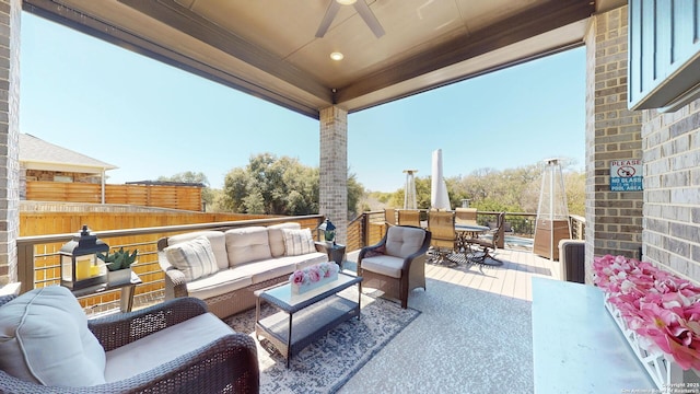 view of patio / terrace with outdoor dining space, outdoor lounge area, and a ceiling fan