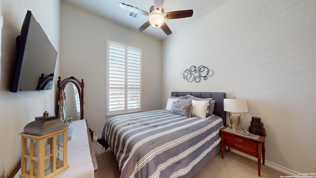 carpeted bedroom featuring visible vents and a ceiling fan