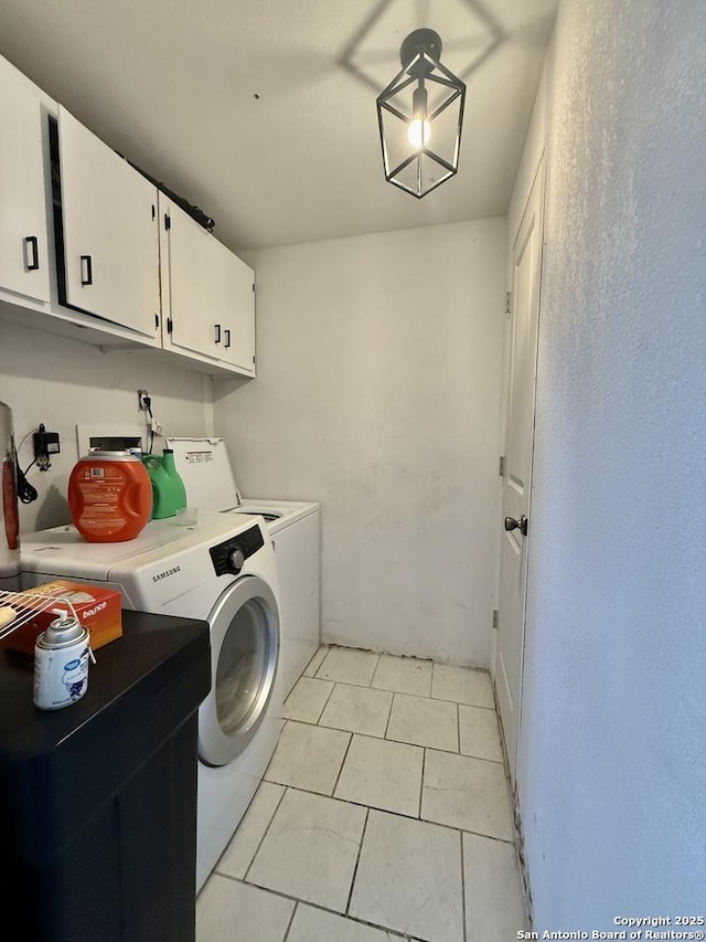 laundry room with washer and dryer, cabinet space, and light tile patterned floors