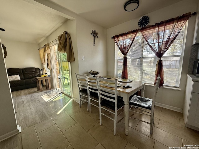 dining room with light tile patterned floors and baseboards