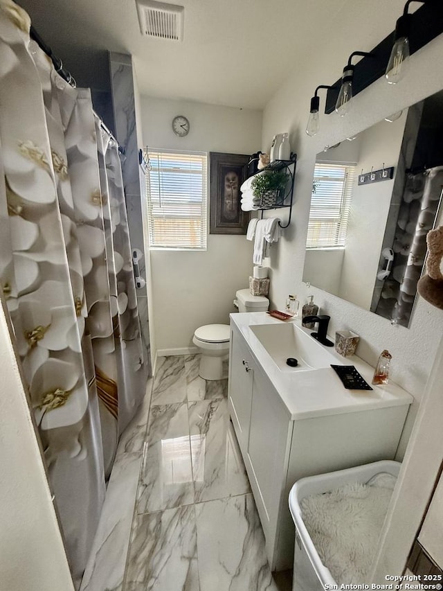 bathroom with visible vents, toilet, a shower with shower curtain, marble finish floor, and vanity