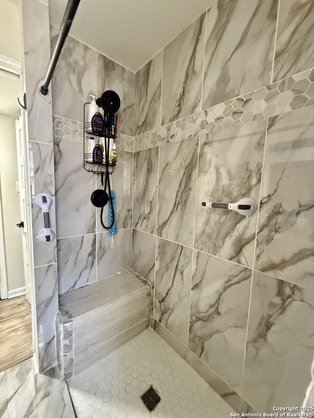 full bath with a tile shower