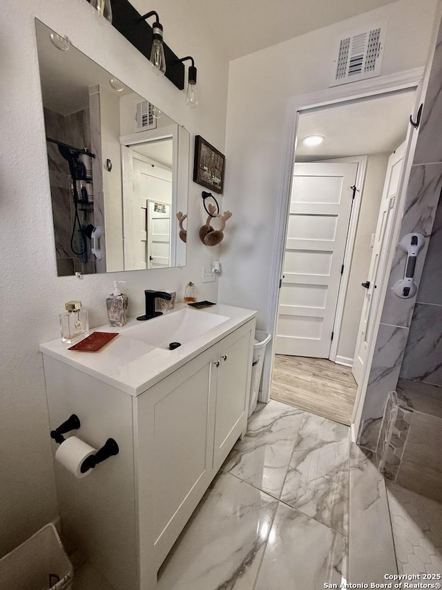 bathroom with visible vents, marble finish floor, and vanity