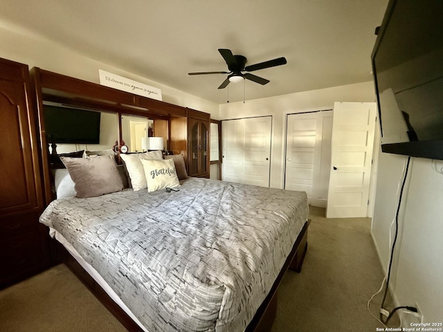 bedroom featuring carpet floors, two closets, and ceiling fan