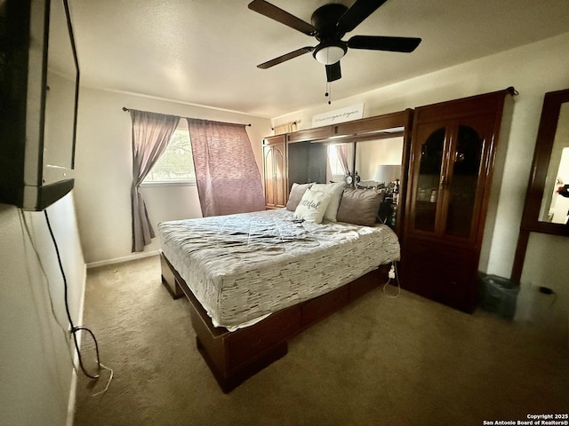 bedroom with a ceiling fan and carpet flooring