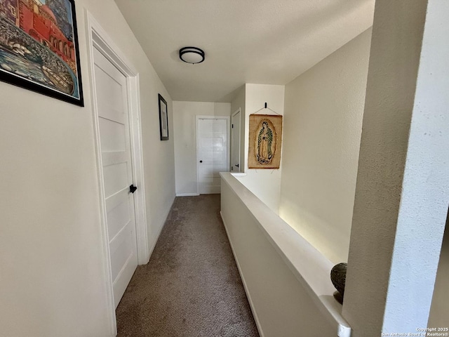 corridor featuring an upstairs landing and carpet flooring