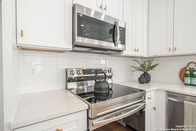 kitchen featuring appliances with stainless steel finishes and white cabinetry