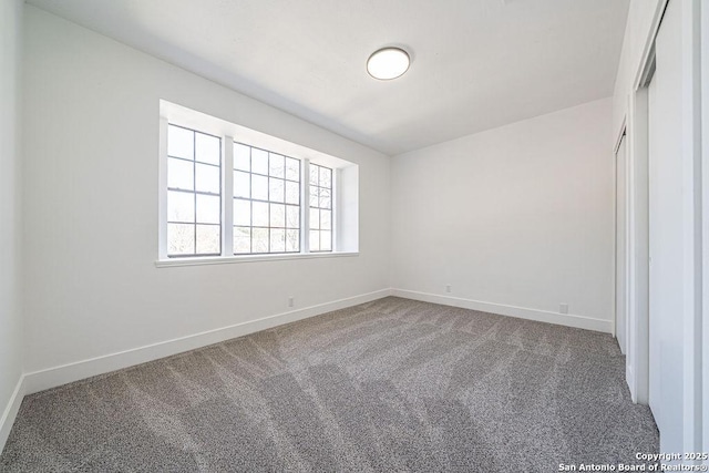 unfurnished bedroom with baseboards and carpet flooring