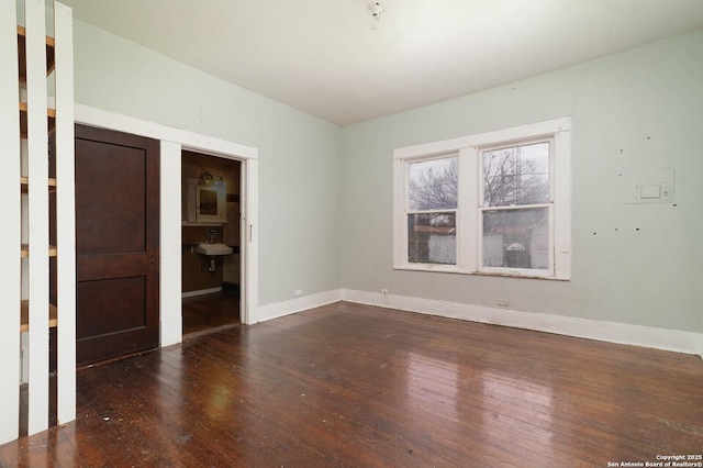 unfurnished room featuring hardwood / wood-style flooring and baseboards