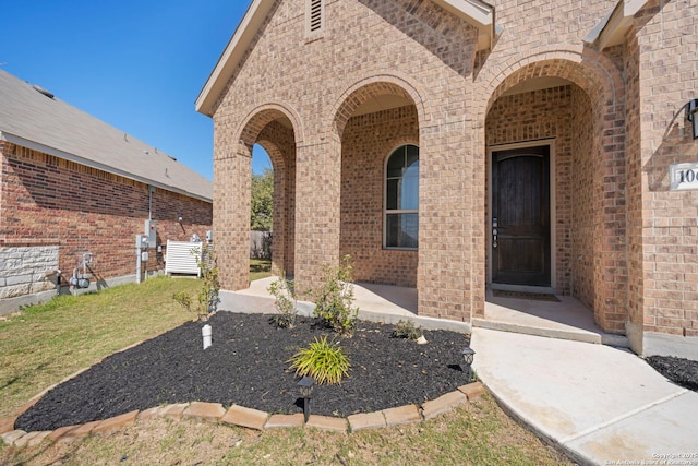 property entrance featuring brick siding