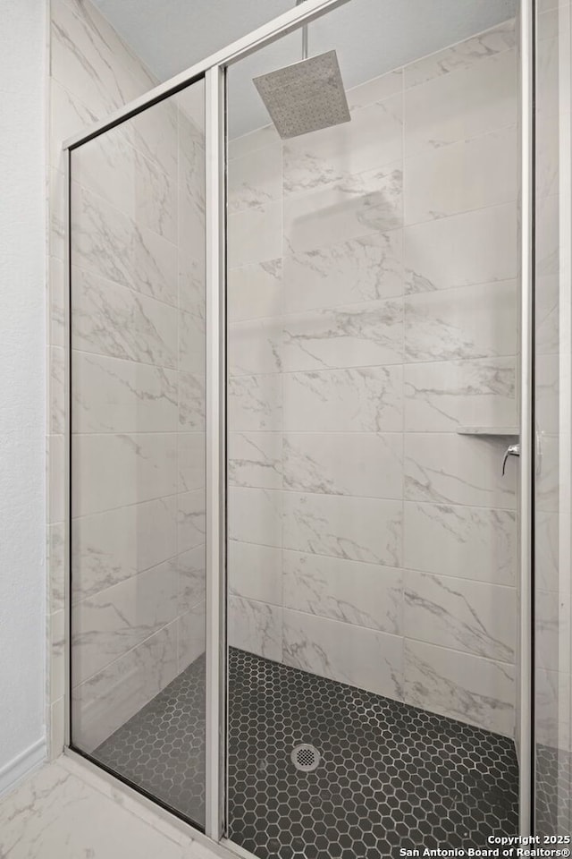10619 Revolver Trl, San Antonio, TX 78254 - bathroom featuring a shower stall and marble finish floor