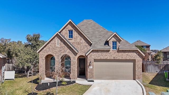 10619 Revolver Trl, San Antonio, TX 78254 - view of front of house with brick siding, a front lawn, fence, a garage, and driveway