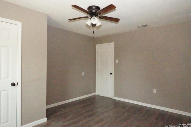 unfurnished room with ceiling fan, visible vents, baseboards, and wood finished floors