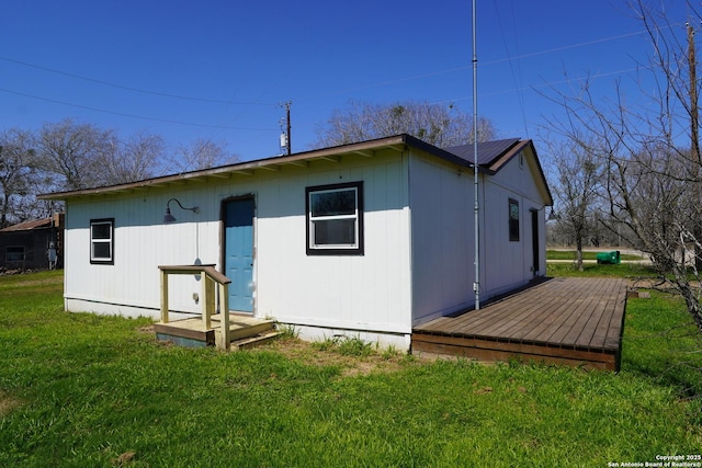 rear view of property featuring a yard