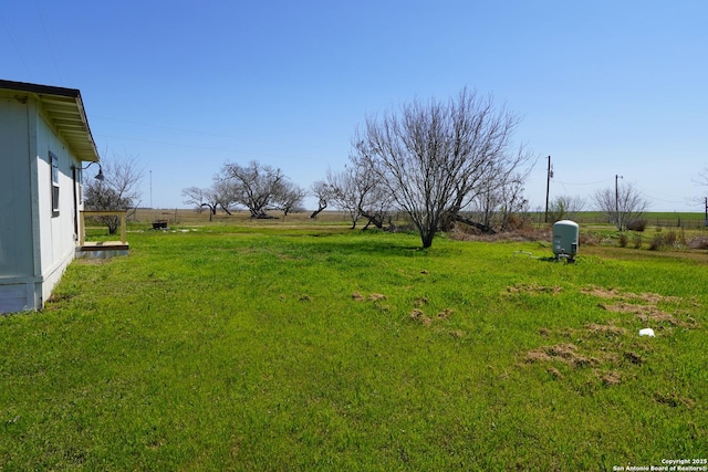 view of yard with a rural view