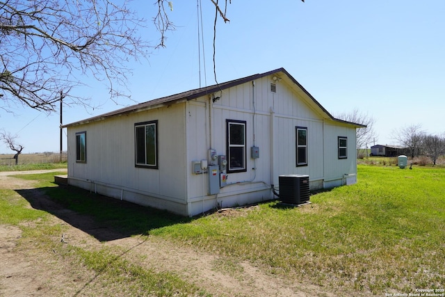 view of home's exterior featuring a lawn and central AC