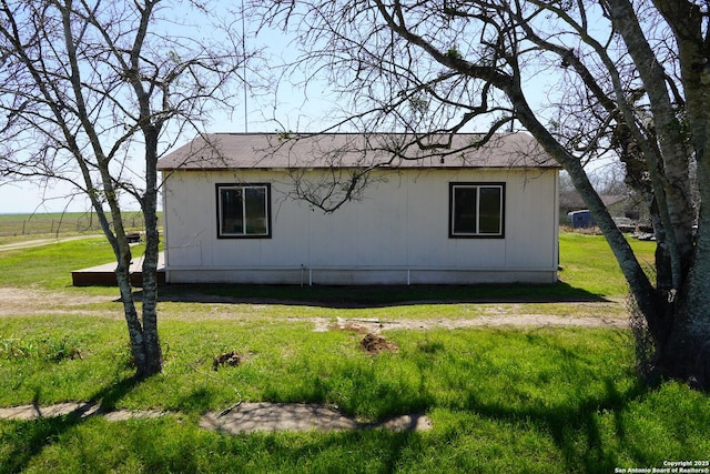 view of side of home featuring a lawn