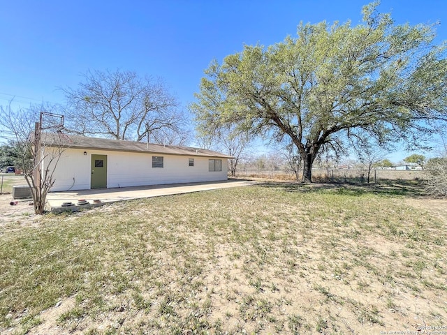 rear view of property with a patio, a yard, and fence