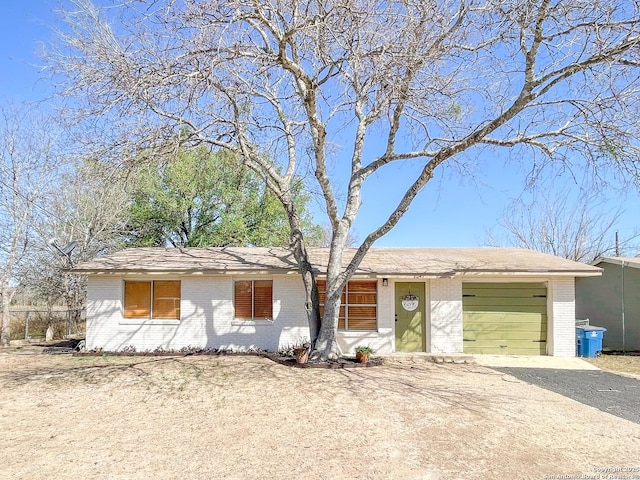 ranch-style home with brick siding, driveway, and an attached garage