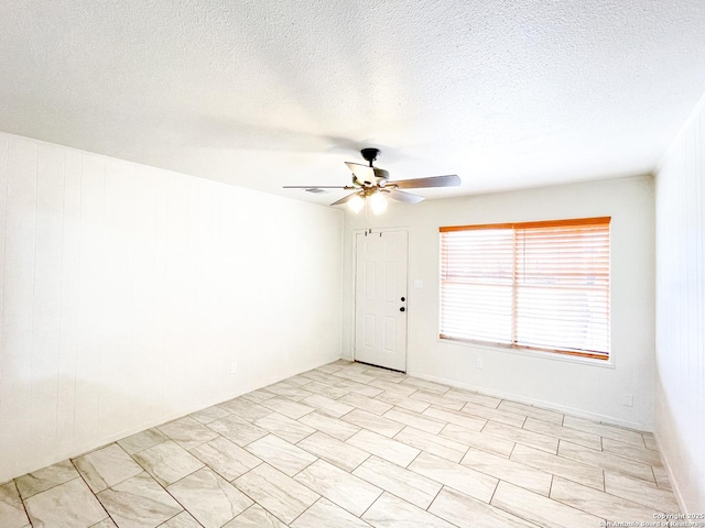 unfurnished room featuring a textured ceiling and ceiling fan